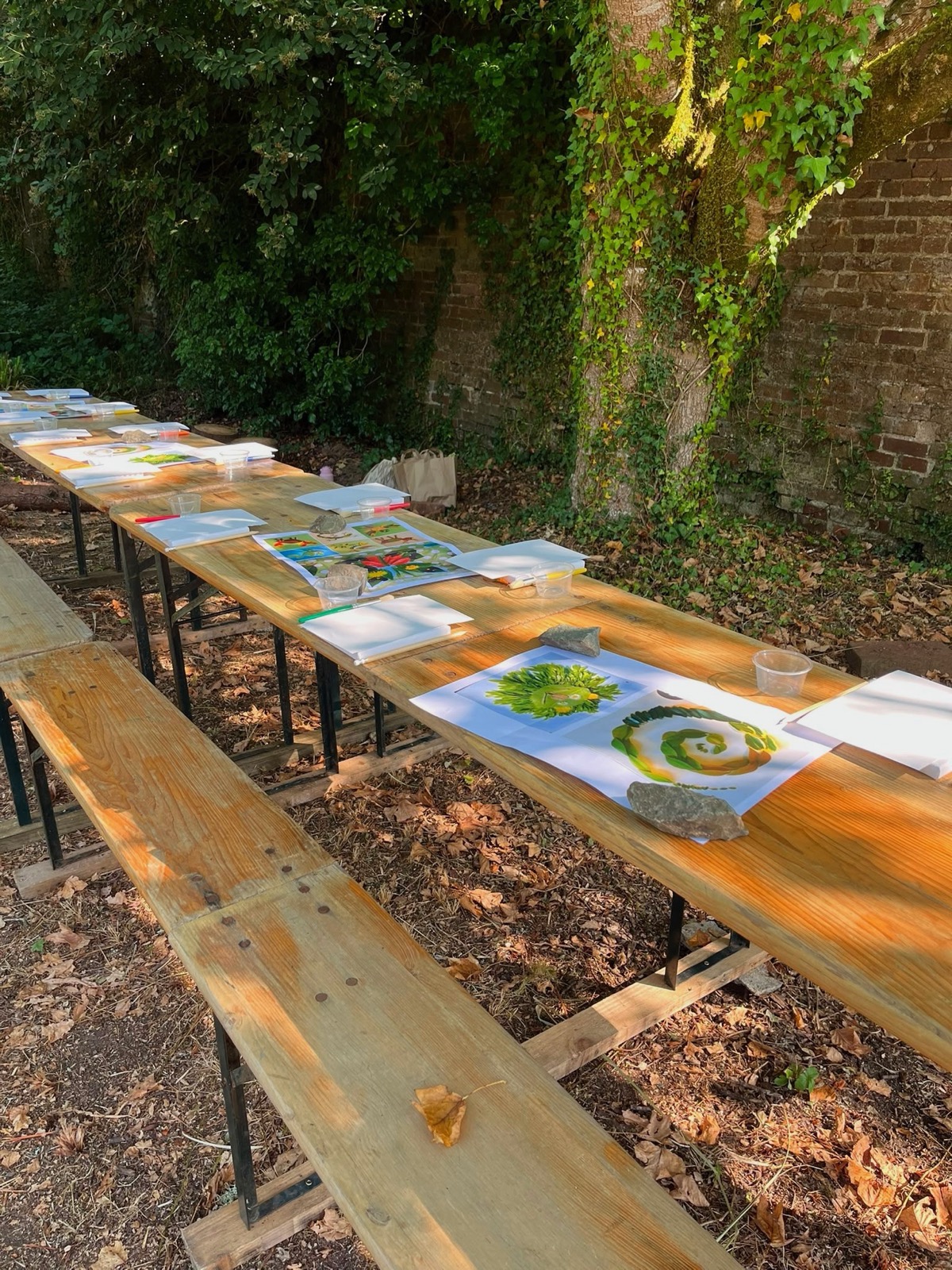 An outdoor table set with creative materials